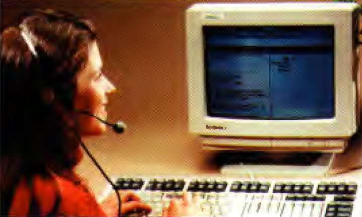 Woman wearing headset in front of computer